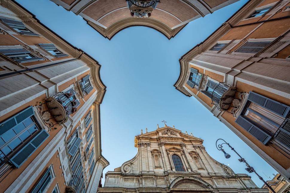 Free Image of Looking Up at a Tall Building With a Clock Tower 