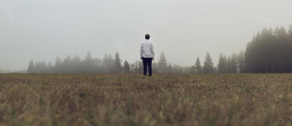 Free Image of Man Standing in Field With Frisbee. 