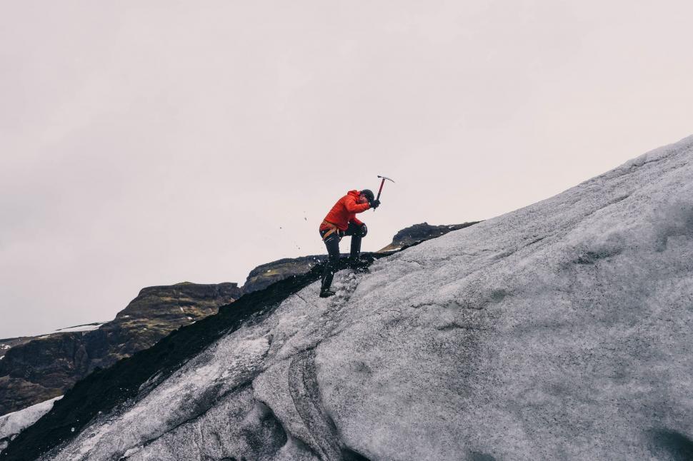 Free Image of Man Standing on Top of Snow Covered Mountain 