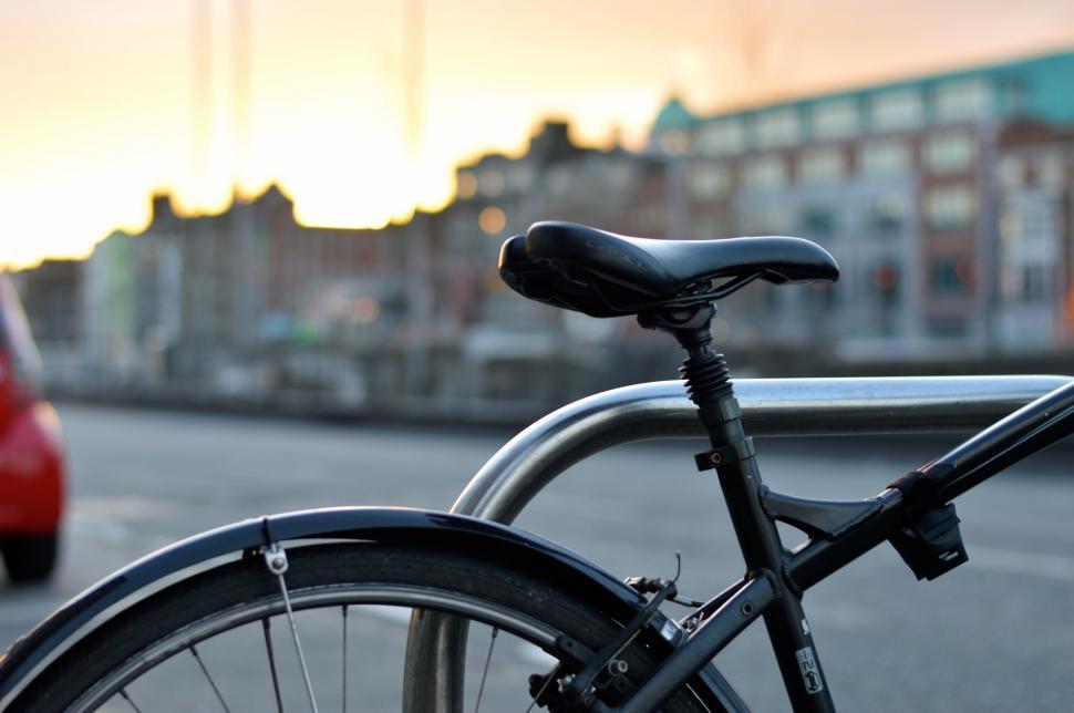 Free Image of Bicycle Parked Next to Red Car on Roadside 