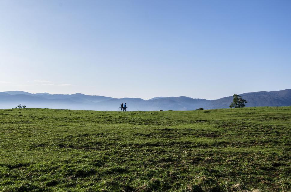 Free Image of Couple Standing on Lush Green Field 