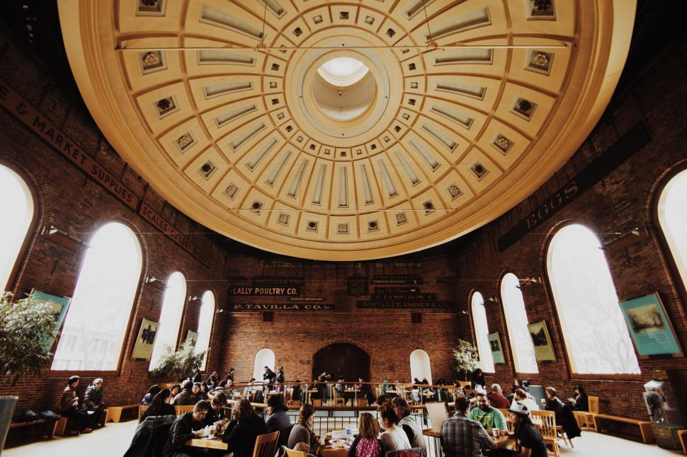 Free Image of Group of People Sitting at Tables in Large Room 