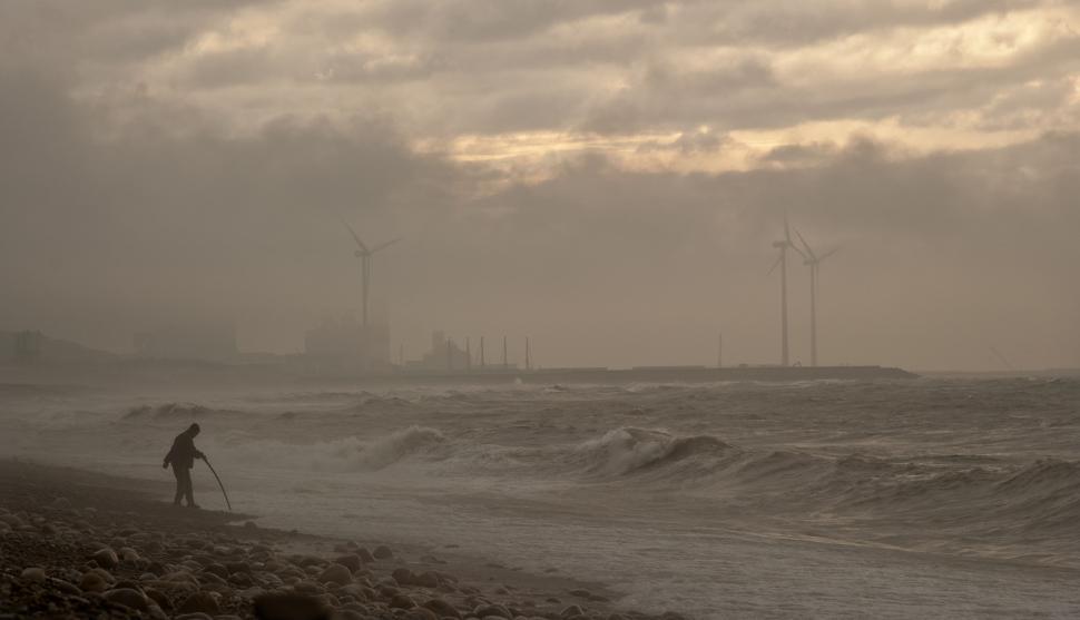 Free Image of Person Walking on Beach Next to Ocean 