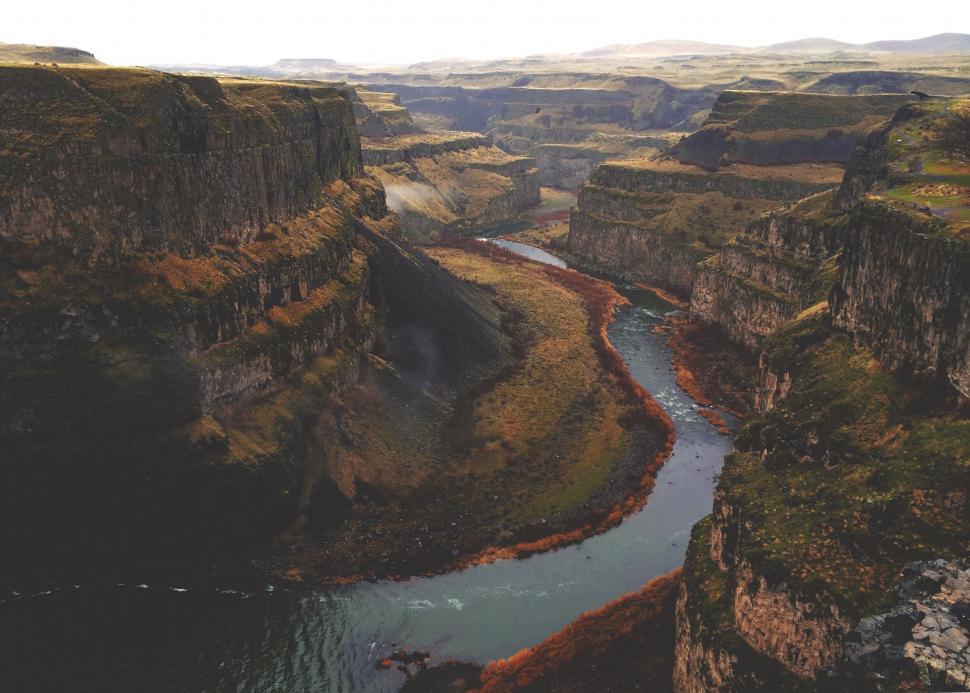 Free Image of River Flowing Through Canyon Surrounded by Mountains 