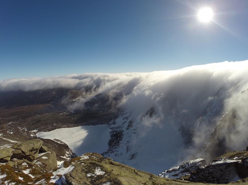 Free Image of The Sun Shining on Snowy Mountain 