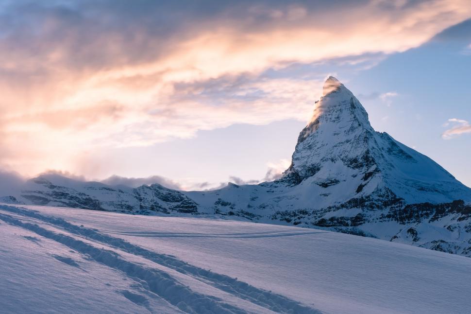 Free Image of Snow Covered Mountain With Tracks in the Snow 