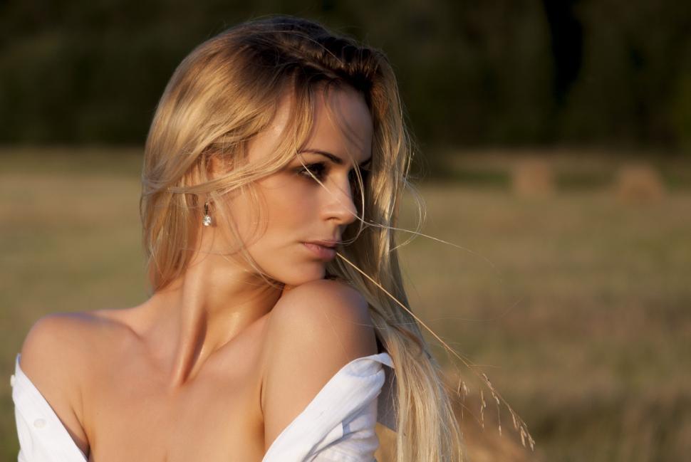 Free Image of Woman With Long Blonde Hair Standing in a Field 