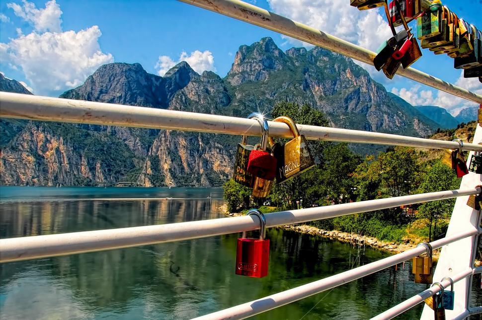 Free Image of Numerous Padlocks Secured on Bridge Railing Above Water 