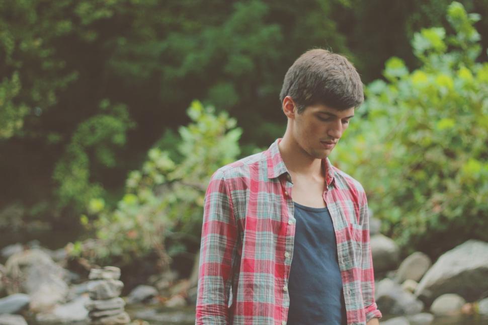 Free Image of Young Man Standing by River 