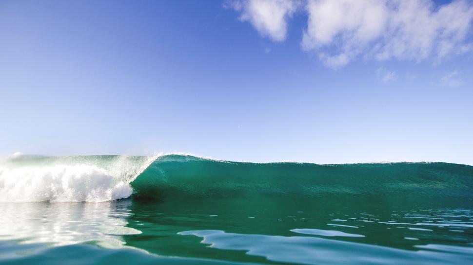 Free Image of Person Riding a Wave on Top of a Surfboard 