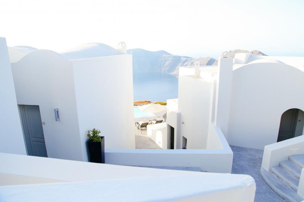 Free Image of Aerial View of White Building Overlooking Ocean 