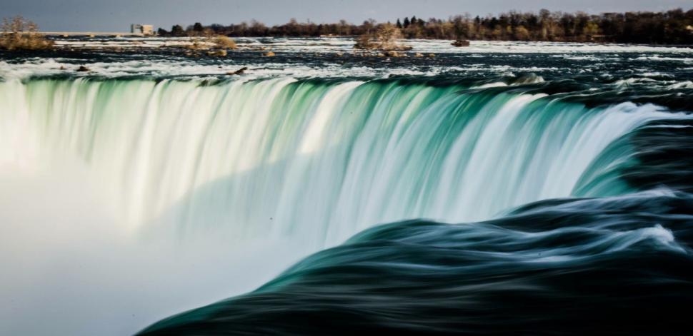 Free Image of Waterfall Painting in the Middle of a Water Body 