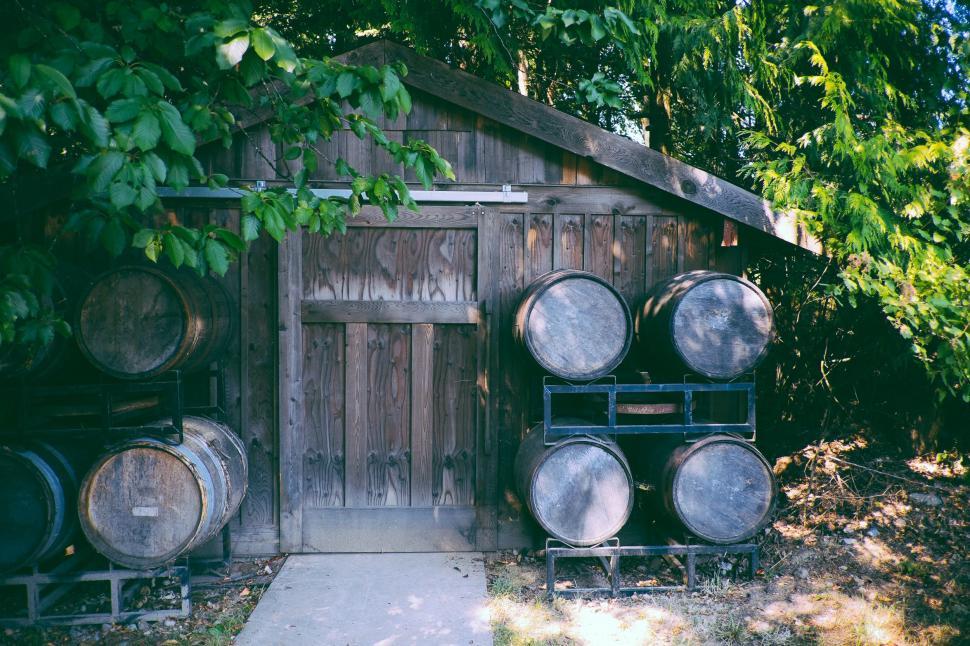Free Image of Stacked Barrels on Wooden Outhouse 