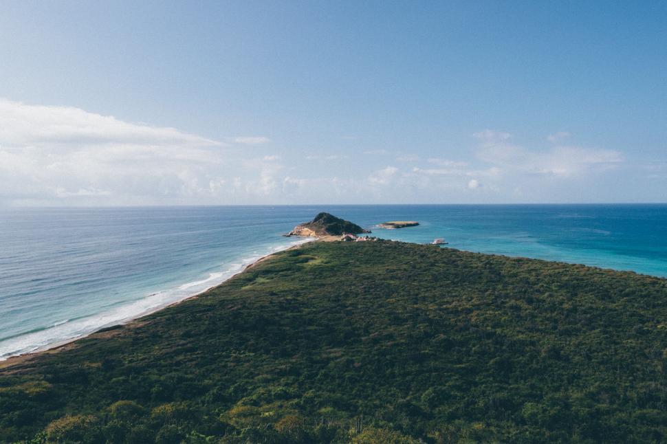 Free Image of Aerial View of Grassy Hill by Ocean 