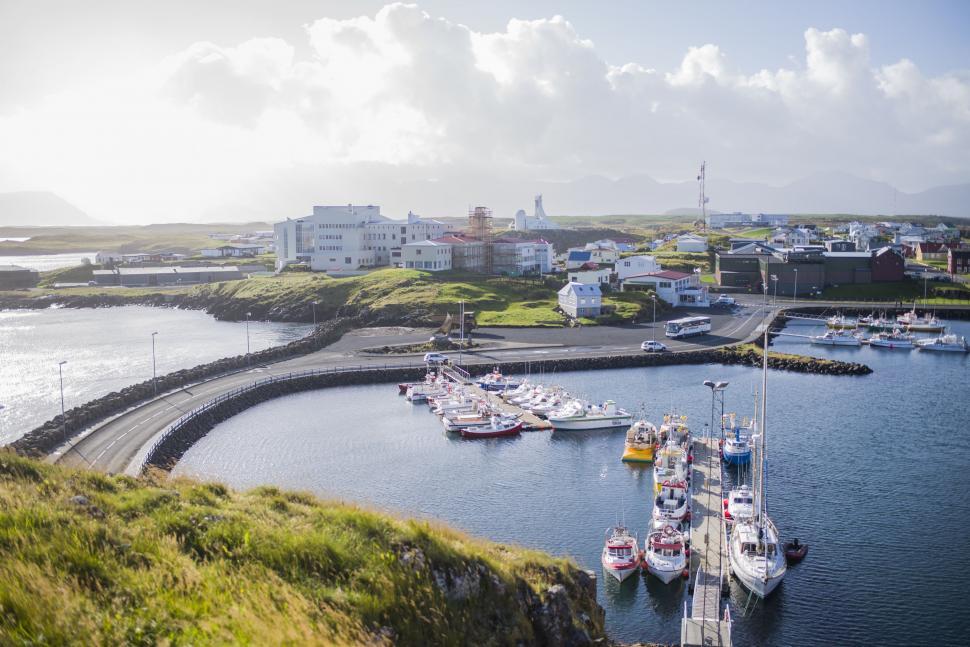 Free Image of Boats Filling Harbor Next to Lush Green Hillside 