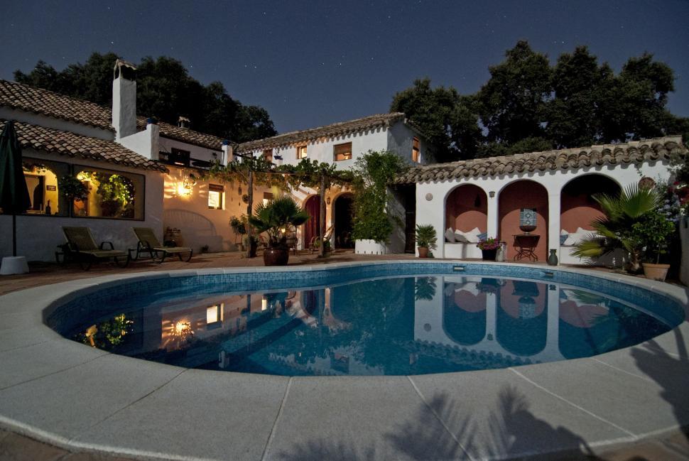 Free Image of Large Swimming Pool in Front of House 