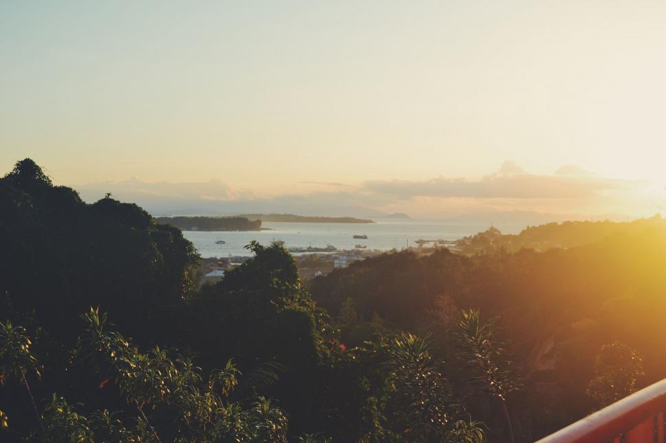Free Image of Person Standing on Balcony Overlooking Body of Water 