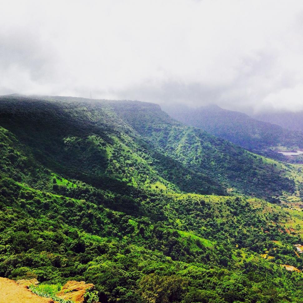 Free Image of Rolling Green Valley Beneath Clear Blue Sky 