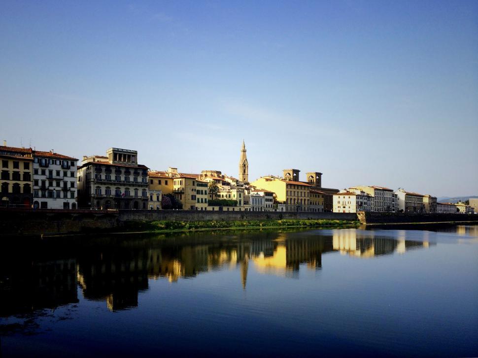 Free Image of River Running Through a City Next to Tall Buildings 