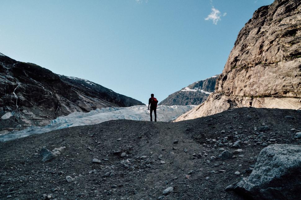 Free Image of Man Standing on Top of Rocky Mountain 