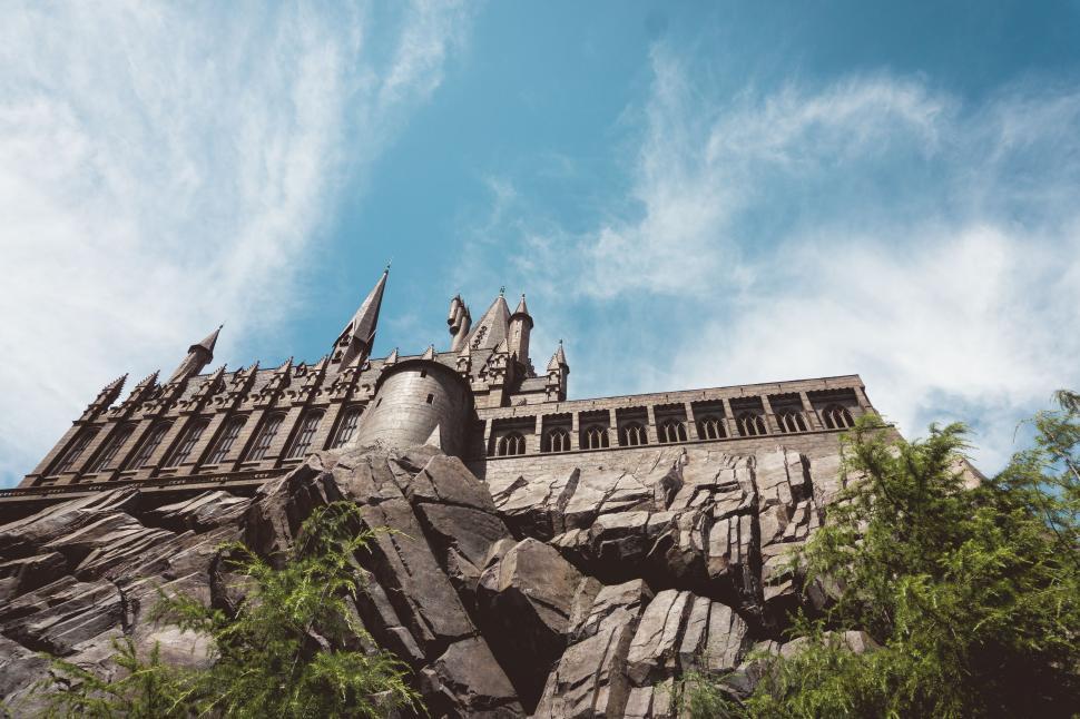 Free Image of Tall Building Atop Lush Hillside 