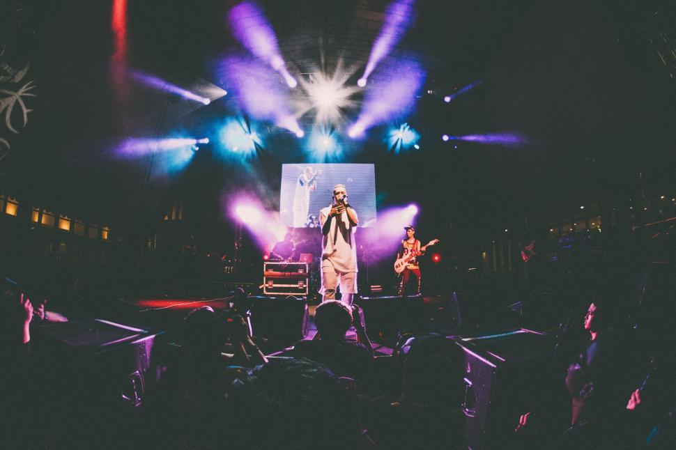 Free Image of Man Standing on Stage in Front of Crowd 