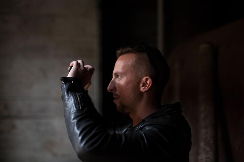 Free Image of Man in Leather Jacket Holding Gun 