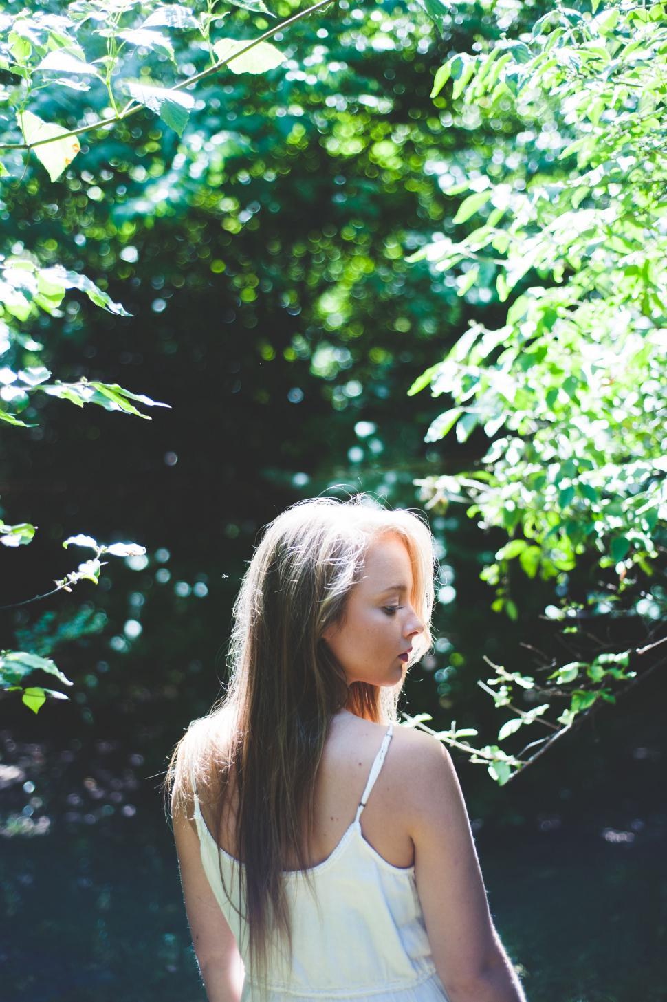 Free Image of Woman Standing in Front of Tree 