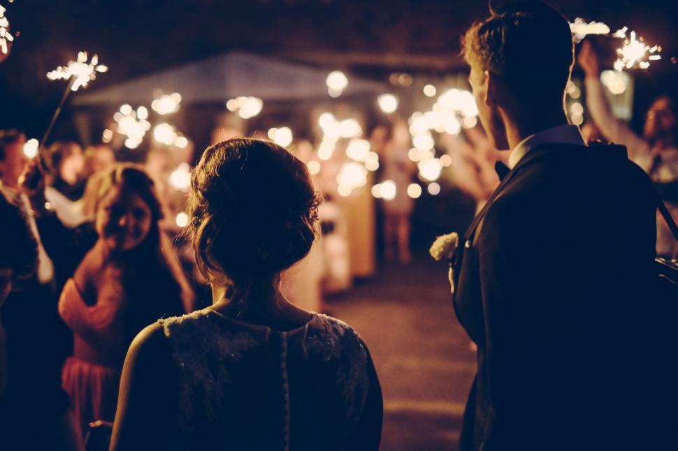 Free Image of Group of People Standing Holding Sparklers 