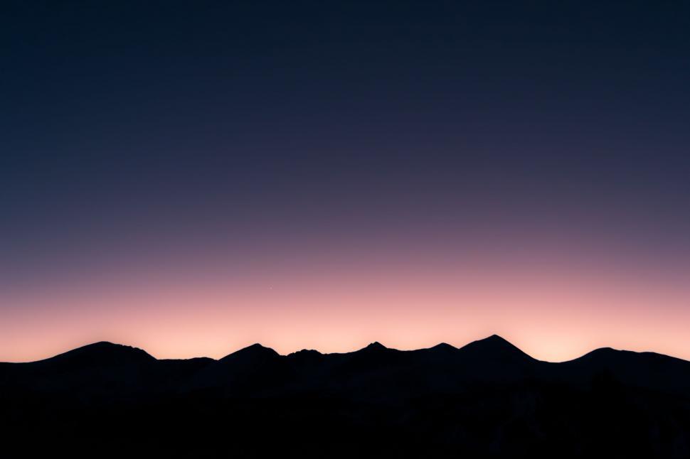 Free Image of Plane Flying Over Mountain Range at Dusk 
