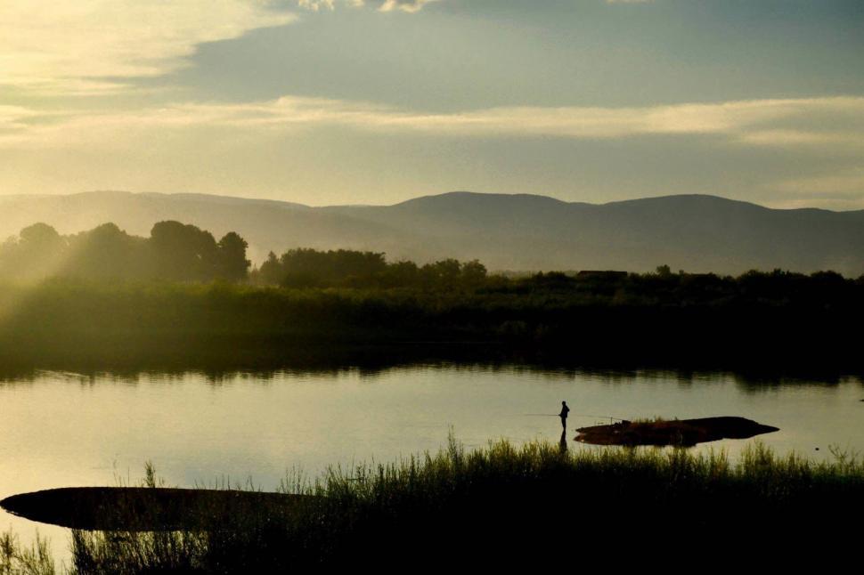 Free Image of Person Standing Near Body of Water 