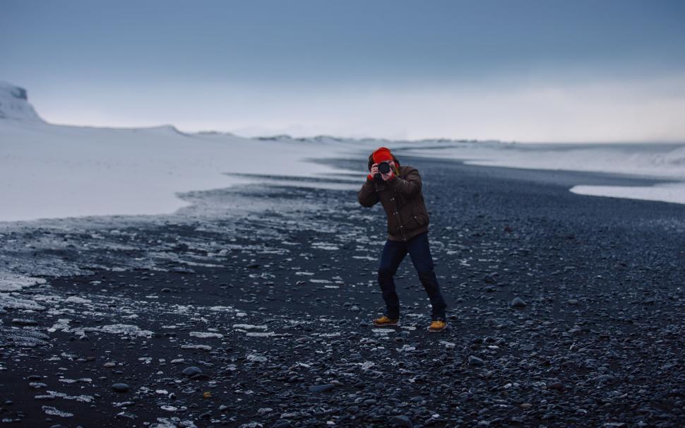 Free Image of Man in Red Hat Standing in Snow 