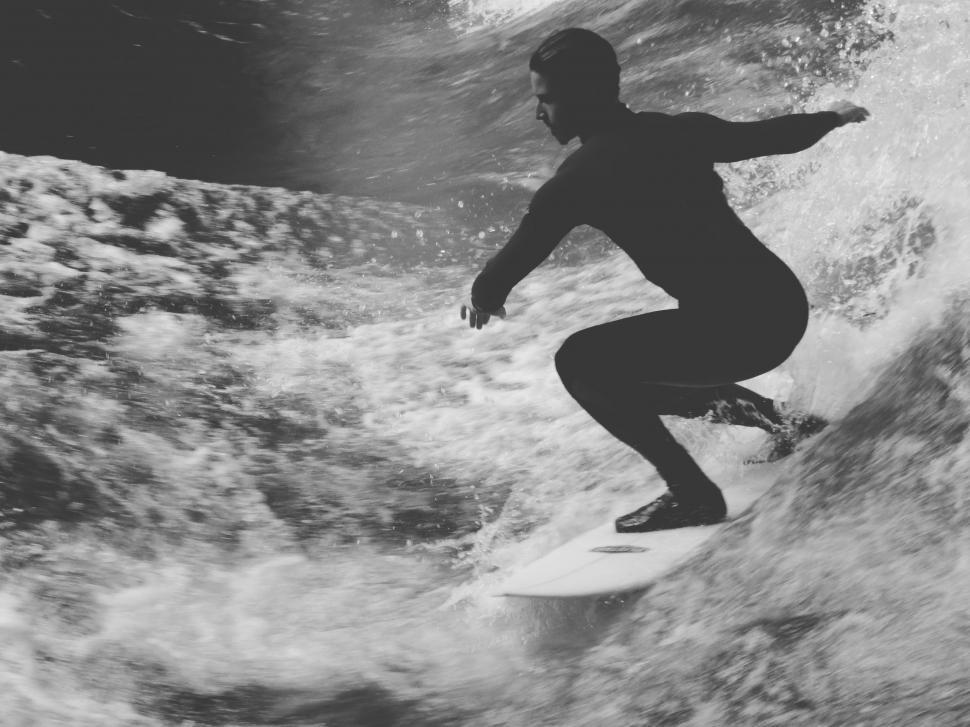 Free Image of Man Riding Wave on Surfboard 