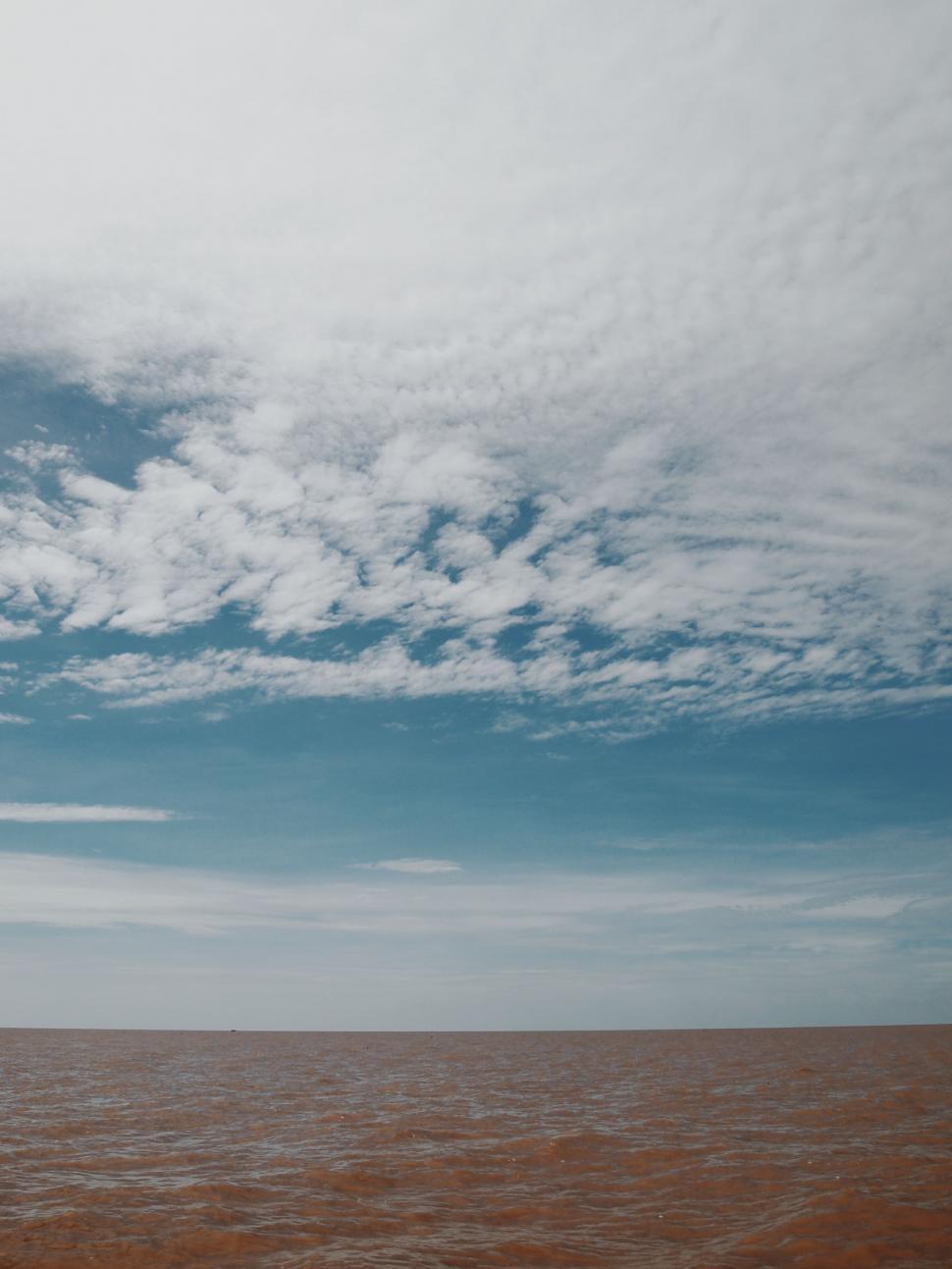 Free Image of Person Riding Surfboard on Large Body of Water 