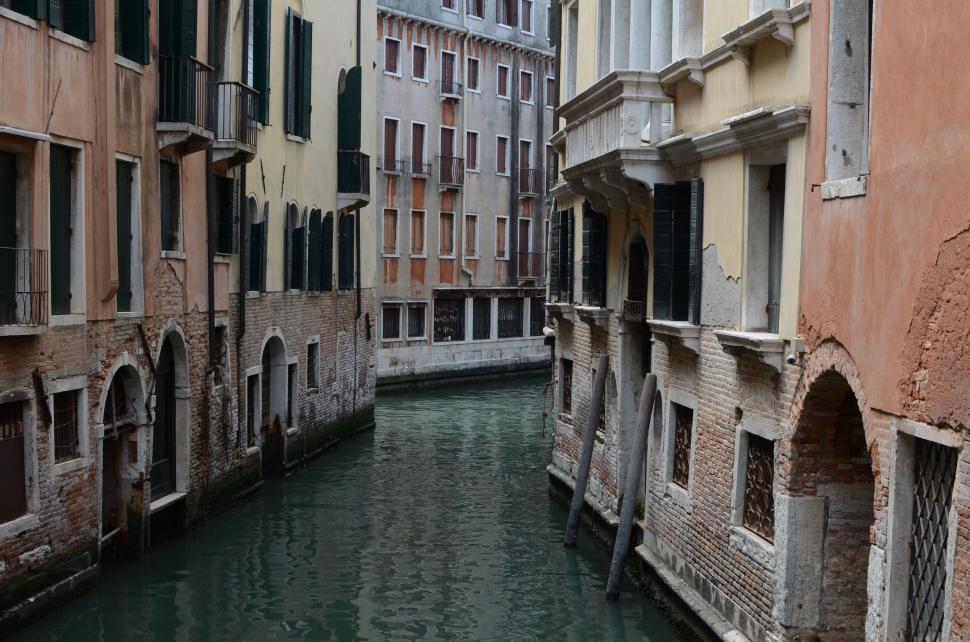 Free Image of Canal Running Through City Next to Tall Buildings 