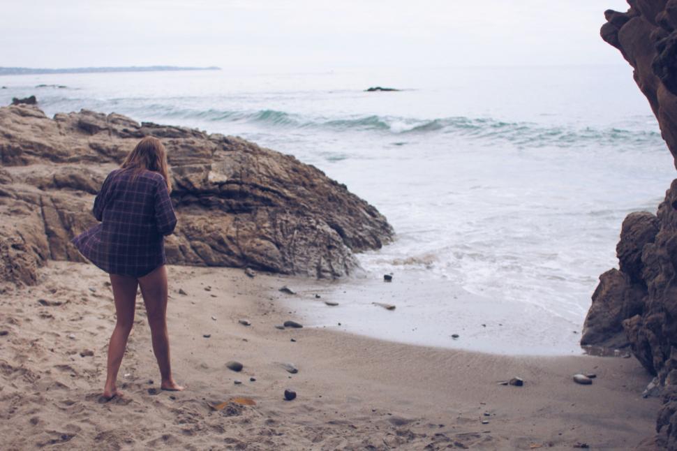 Free Image of Person Standing on Beach Next to Ocean 