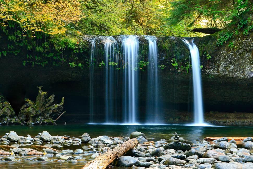 Small waterfall with water splashing and tumbling over the rocks