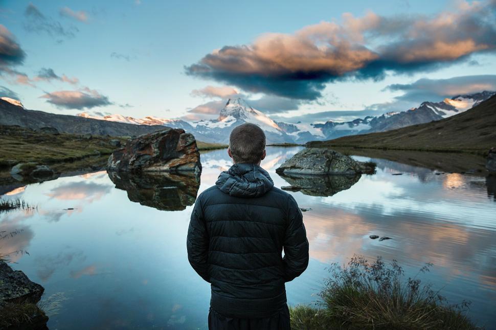 Free Image of Person Standing in Front of Body of Water 