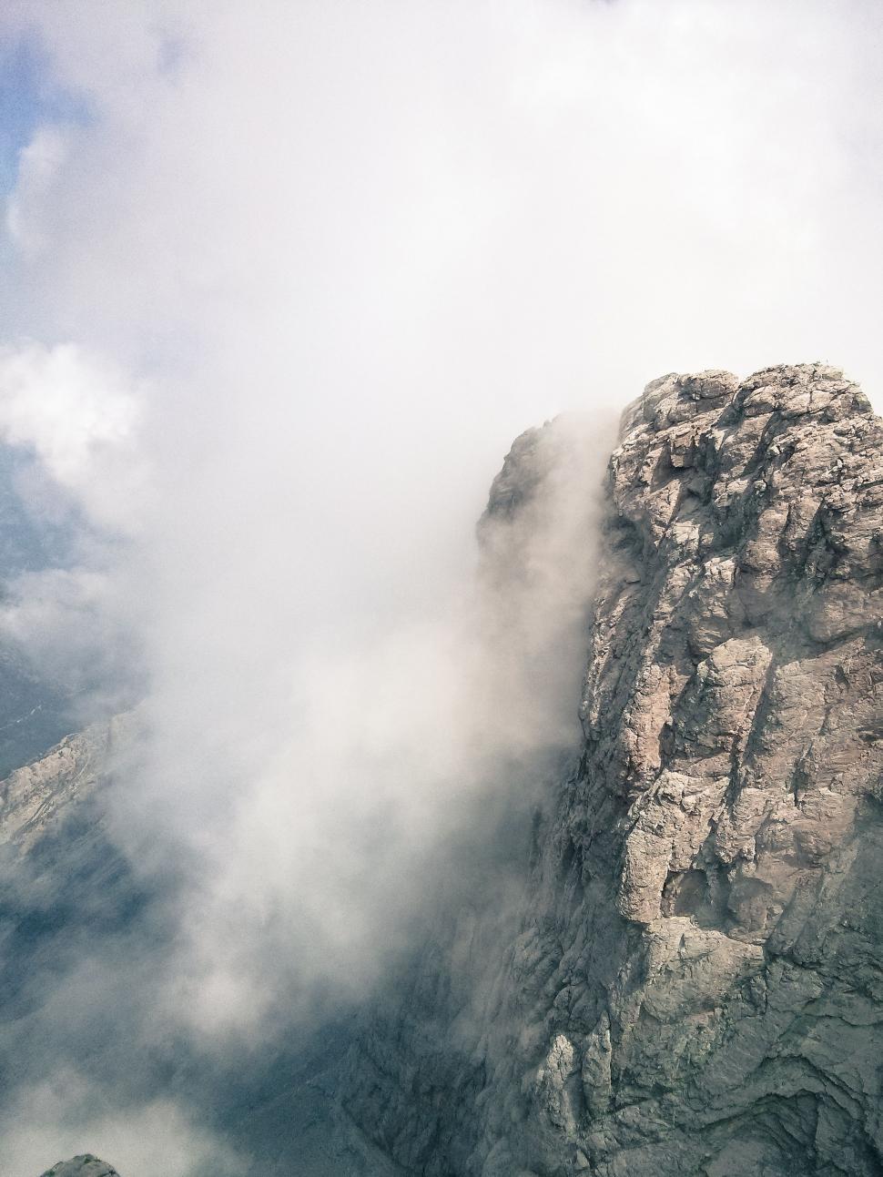 Free Image of Towering Mountain Emitting Clouds 