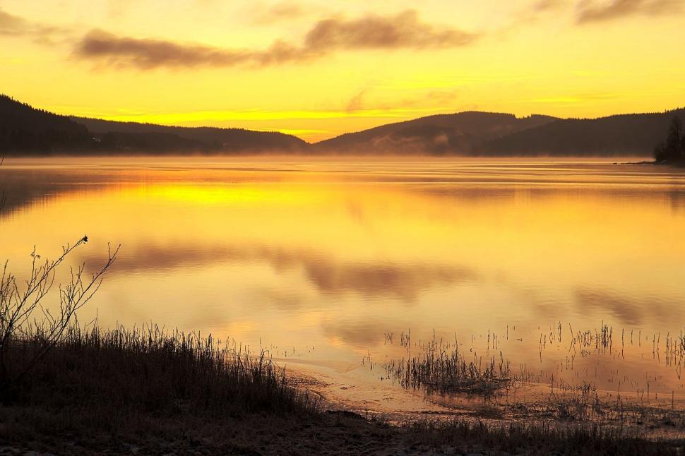 Free Image of Cloudy Sky Over Large Body of Water 