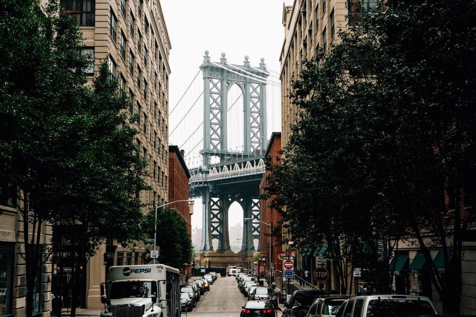 Free Image of City Street With Bridge in Background 