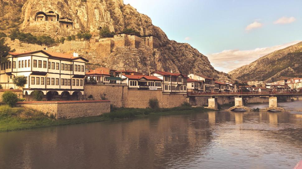 Free Image of River Running Through City Next to Mountain 