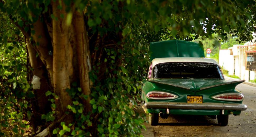 Free Image of Green Car Parked on Side of Road 