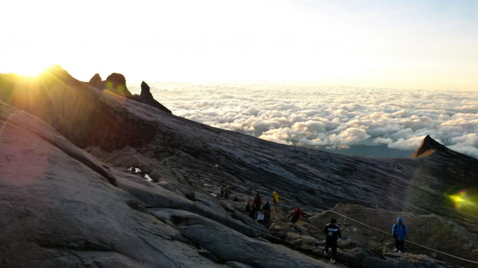 Free Image of Group of People Standing on Top of a Mountain 