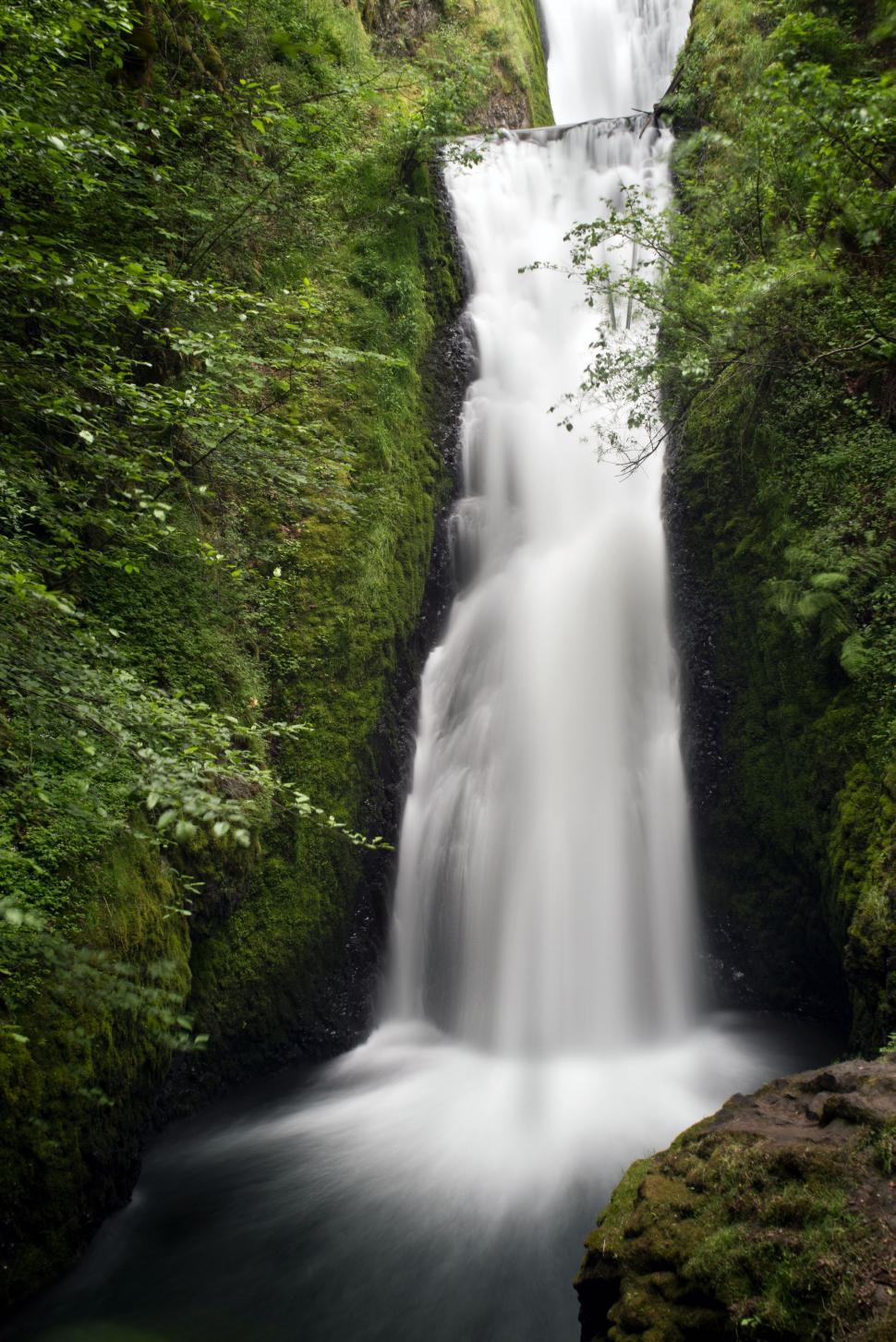 Small waterfall with water splashing and tumbling over the rocks