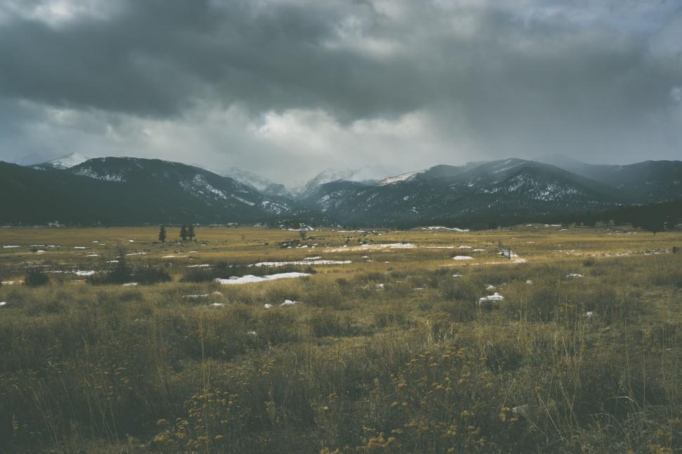 Free Image of Grassy Field With Mountains in the Background 