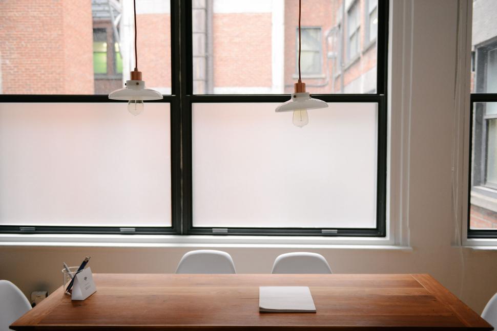 Free Image of Table With Phone by Window 