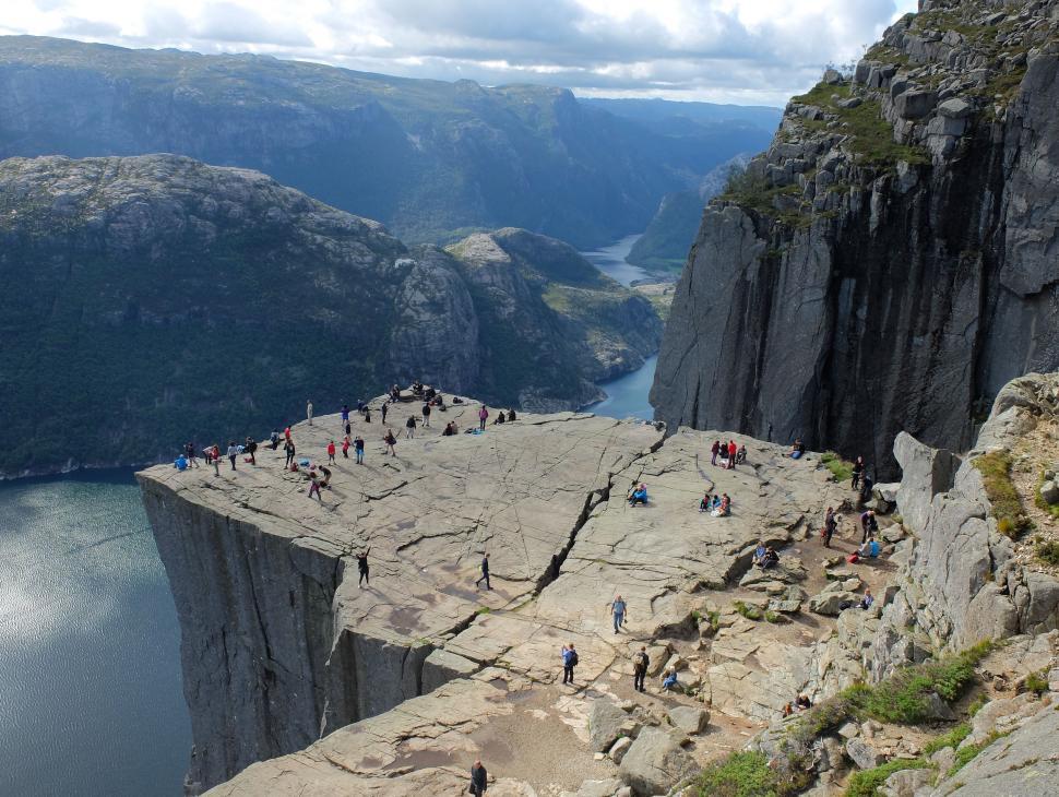 Free Image of Group of People Standing on Top of a Cliff 