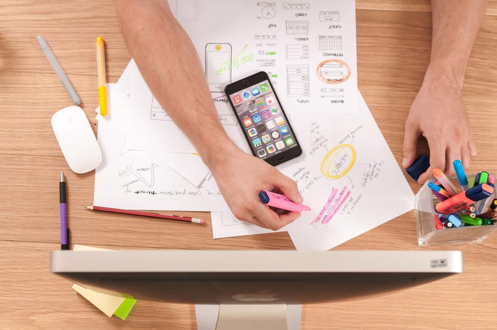 Free Image of Person Using Cell Phone on Desk 