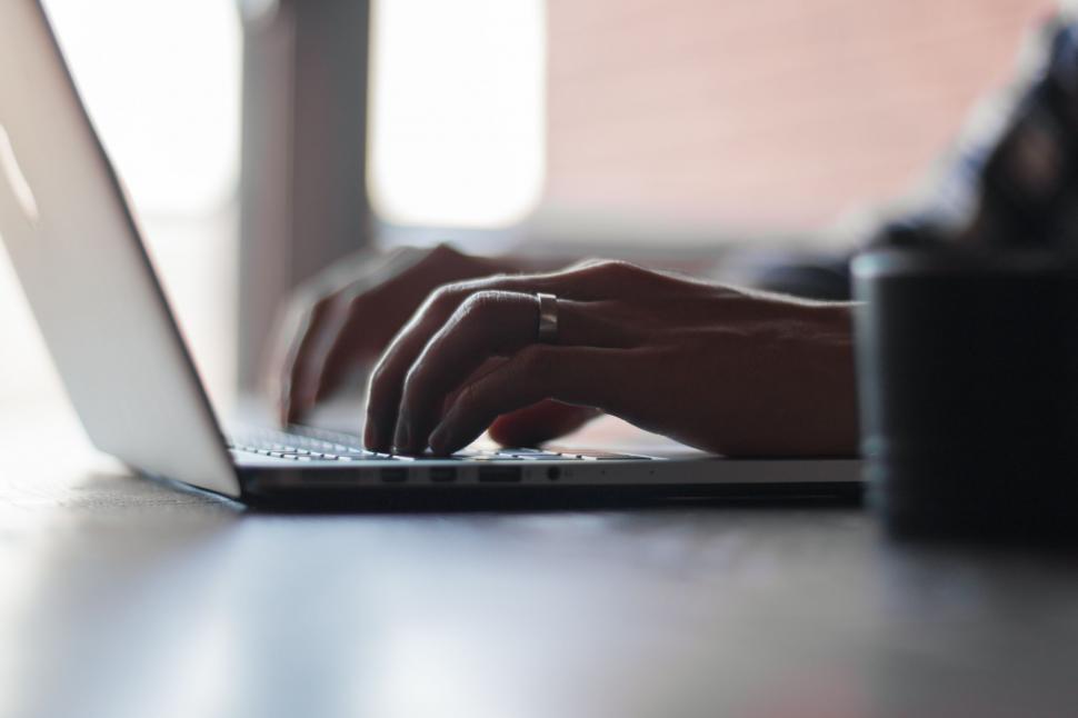 Free Image of Person Typing on Laptop at Table 